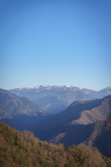 Obraz premium Mountain Ridges with Autumn Forest and Blue Sky