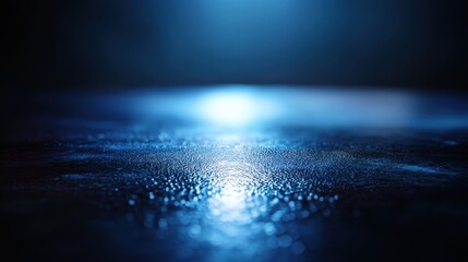 Obraz premium Abstract blue light reflection on a wet surface creating a serene and dreamy atmosphere with gentle textures and subtle highlights for artistic backgrounds