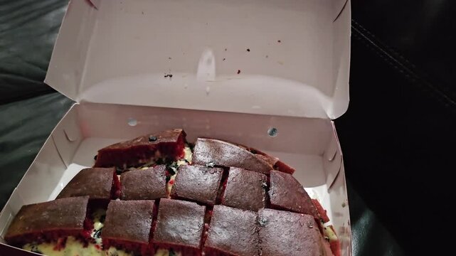close up of an oven,Martabak manis red velvet with black cookies and cheese filling.Sweet Indonesian pancake filled with black cookies and cheese.Sweet red velvet martabak,Terang bulan 