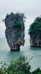 Thailand - picturesque limestone cliffs in the emerald sea and lush tropical greenery