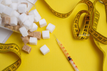 Diabetes and weight management. Sugar, syringe, and measuring tape