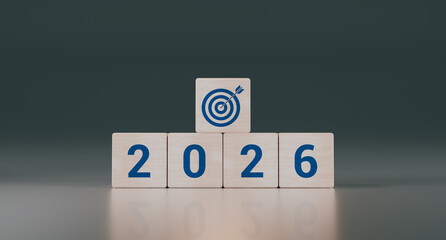 Wooden cubes with the text 2026, an arrow, and a target. Concept of business goals, strategy, and financial planning for the new year. 3D rendering.