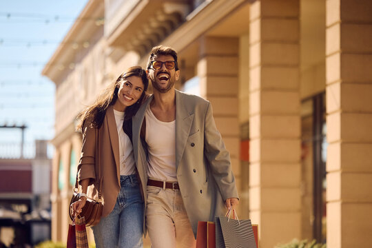 Cheerful couple spending a day in shopping.