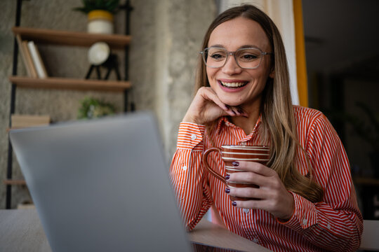Woman smiling during video call using laptop