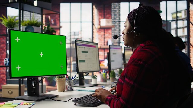 Call center agents tracking shipments in office using green screen computer. Customer center workers use chroma key PC to locate clients packages and provide status updates, camera B - Powered by Adobe
