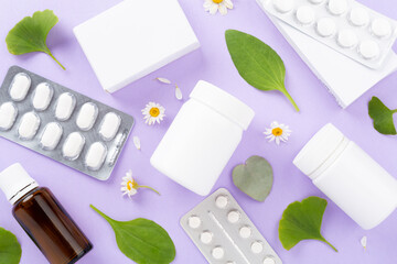 Herbs and flowers with medicines on color background, top view