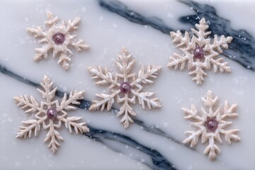 Decorative snowflake cookies with glitter center on a white marble background. Elegant winter holiday dessert for Christmas and New Year.