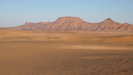 A trip to Sahara desert in Algeria. Beautiful 
african travel photo. Sandy landscapes, mountains, rocks,
dunes, and nature. Summer vacation in arab country.