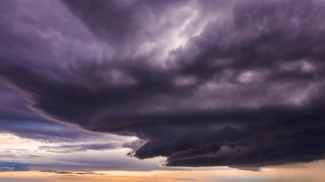 A dramatic view of dark storm clouds rolling across the sky, foreshadowing an approaching tempest. The sky is filled with swirling shades of gray and purple, creating a sense of awe Stock Video