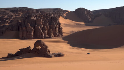 A trip to Sahara desert in Algeria. Beautiful 
african travel photo. Sandy landscapes, mountains, rocks,
dunes, and nature. Summer vacation in arab country.
