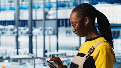 Engineer in smart factory implementing automated workflows and control systems replacing manual operations with computerized processes. Technician integrating sensors into production lines, camera A