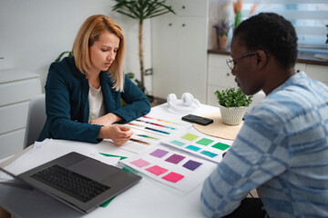 Creative women collaborating on design project with color swatches