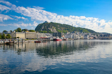 Naklejka premium View of the town of Alesund from the water including the viewpoint Aksla, Art Nouveau buildings and boats. Beautiful scenic down town harbour view. Alesund, Norway.