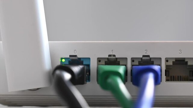 Woman plugging cable into router. 