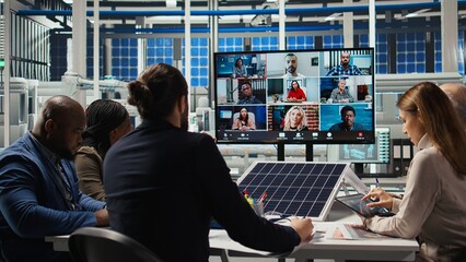 Photovoltaics plant researchers doing internet videocall, working on breakthroughs in durability....