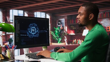 African american IT expert doing maintenance on artificial intelligence neural networks, writing code on terminal window. Male tech support engineer doing checkup on AI systems. Camera B.