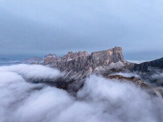 Passo Giau in Dolomites Alps, Italia. Drone view of mountains in fog. Landscape in a popular tourist destination for hiking and trekking in the Alp.