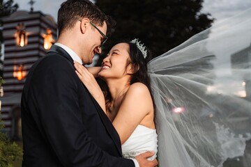 Interracial couple embracing during wedding day