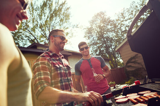 BBQ, friends or men in backyard with grill, bonding or good time in outdoor party. Happiness, celebration or people at house with meat preparation, reunion or fun conversation in social gathering.