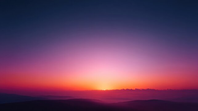 Breathtaking sunset over rolling hills with vibrant hues of purple, pink, and orange illuminating the sky and creating a serene landscape scene