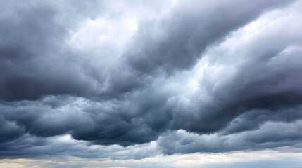 Obraz premium Dramatic Sky with Dark Storm Clouds and Bright Light Peeking Through on a Gloomy Day Over a Vast Open Landscape