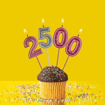 Candles forming the number 2500 - Yellow background.