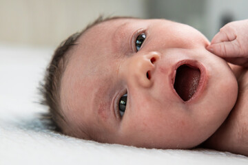 Newborn baby yawning, expressing innocence and early life