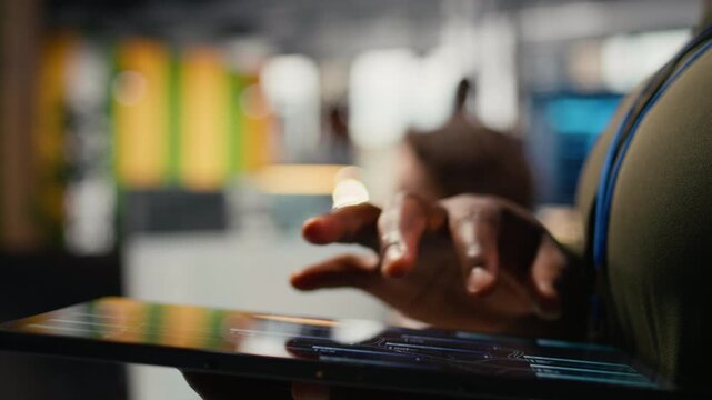 Close up of tablet used by programmer in office to accelerate complex artificial intelligence calculations. IT employee using touchscreen device to train deep learning datasets systems, camera A