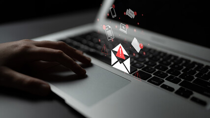 A person engages with a laptop, receiving notifications about important communications. The image...
