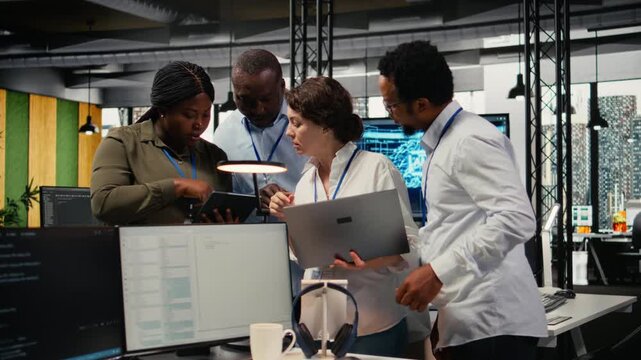 Portrait of smiling engineering team in office working with software development programming languages. Happy startup company coworkers using devices to do code testing and quality assurance, camera A