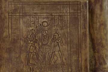 Ancient Egyptian carving with figures and symbols 