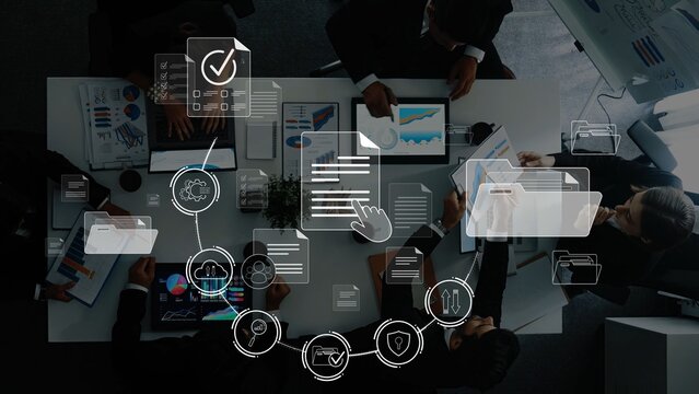 A dynamic office scene showing a diverse team collaborating on business strategies using digital tools, showcasing charts and visual data elements in an engaging environment. Raster
