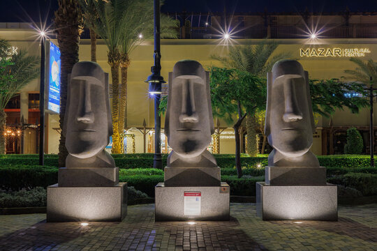 Three Moai statues illuminated at night at a cultural center on September 3, 2023 in Hurghada, Egypt
