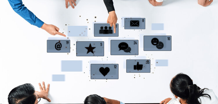 A diverse group of individuals engaging around a touchscreen display, highlighting social media icons and promoting collaboration in a modern office setting. Trope