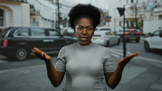 Woman gesturing oath on city street portrays expressive communication in urban public environment with traffic backdrop illustrating diverse setting. - Powered by Adobe
