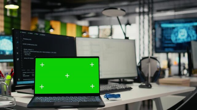 Chroma key laptop in empty startup office with artificial intelligence program running. Isolated screen notebook in AI industry startup workspace leveraging deep learning tech, close up
