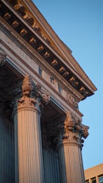 neoclassical. Grand neoclassical architecture with detailed pillars and staircase, embodying timeless elegance and design. real-estate listings.