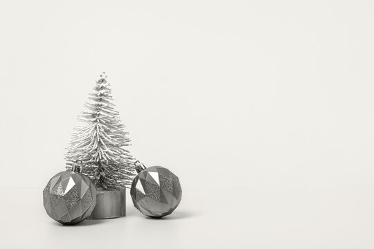 Demonstrating the colors of 2026 - Cloud Dancer. Christmas background with white tree and Christmas balls on table. Christmas and New Year design holiday card - Powered by Adobe