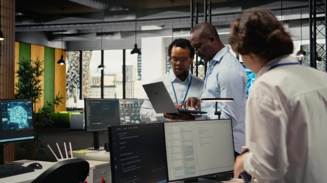 Programmers in office doing software development to launch new features, brainstorming ideas. Teamworking colleagues in startup company writing computer programs, camera A