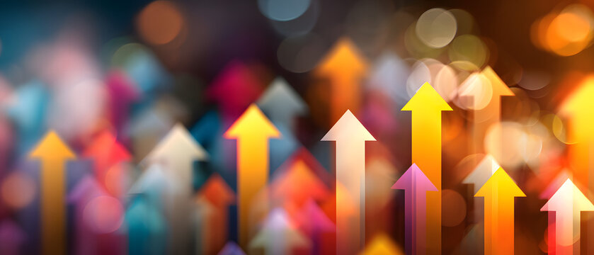 An abstract image featuring multicolored, luminous arrows pointing upwards against a soft-focus, bokeh background, conveying dynamism and growth.