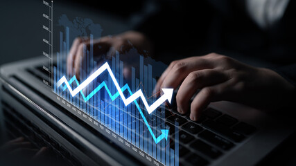 Hands typing on a laptop with digital financial graphs and charts overlay, representing market trends and analytical insights in a modern business setting. Scalp
