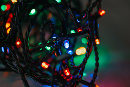 Garland lights and multicolored bokeh close-up.Close-Up of Christmas Lights with Bokeh Effect.Tangled String of Christmas Lights