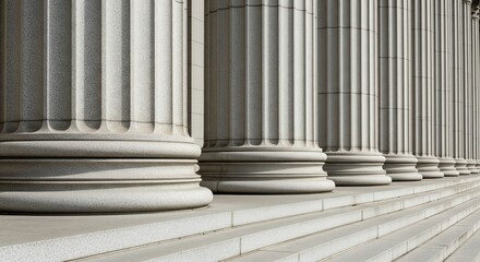A row of massive classical stone columns in perspective, close-up view showing the base and fluted texture, granite stone material, architectural photography, steps leading up to the pillars,