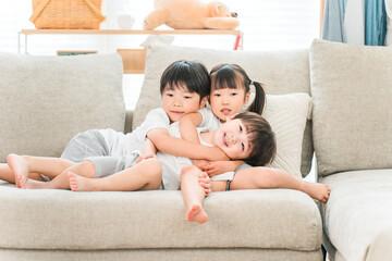 Fototapeta premium A close brother and sister on the sofa in the living room 