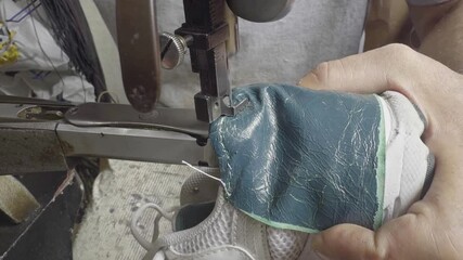 Shoe Repairman Repairs Shoes by Sewing Them on a Machine Footage.