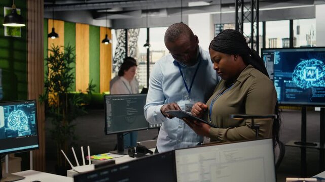 Team of software developers in office automating workflows using artificial intelligence. IT staff members refining deep learning computational models for faster processing, camera A