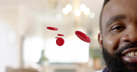 Man speaking, causing animated red blood cells to rotate and pass in front, showing health concept