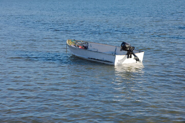 Small White Boat Floating on Calm Water, Seaside Scene with Gentle Waves in Gulfport, FL.
Sea water, reflecting soft light. The scene conveys solitude and peacefulness, ideal for travel, coastal lifes