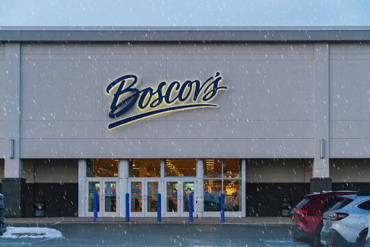 New Hartford, NY - Nov 27, 2025: Close-up view of Boscov&rsquo;s department store&mdash;Sangertown Square Mall location during snowfall, showcasing seasonal retail access and holiday shopping