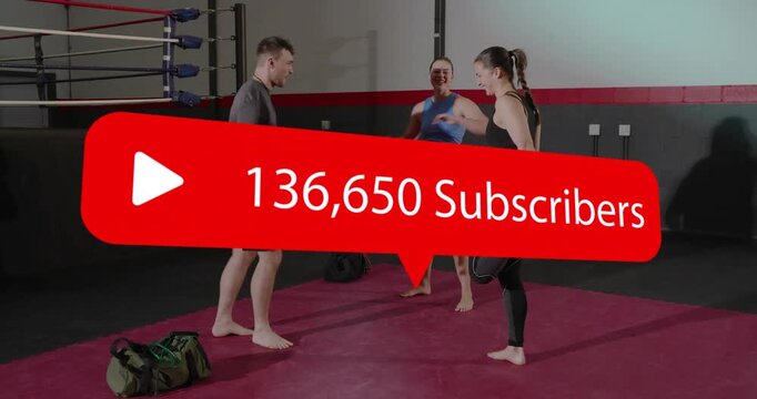 Three fitness participants shifting and smiling on red mat in gym as red subscriber banner rising
